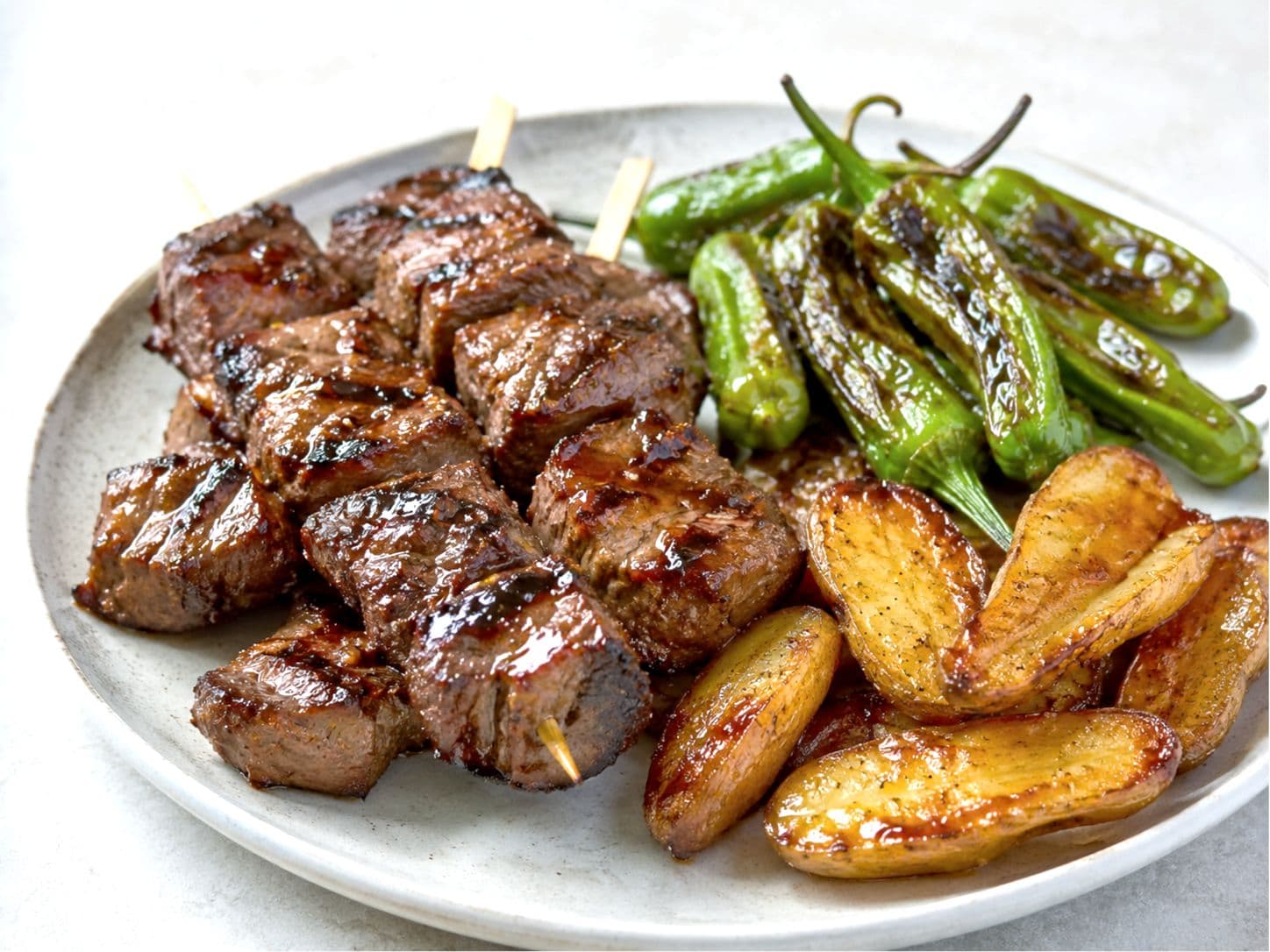 Miso-Glazed Steak Skewers with Blistered Shishitos & Crispy Fingerlings